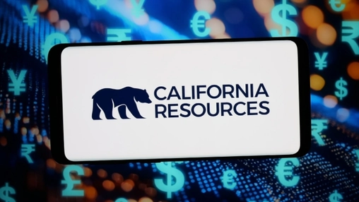 Smartphone showing the California Resources bear logo against a blurred background of currency symbols